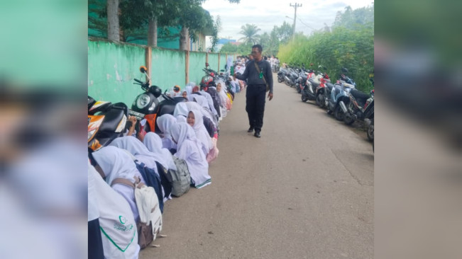 Para pelajar terpaksa belajar di tepi jalan gegara kebijakan Pemkab Deli Serdang. [Istimewa]