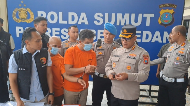 Tersangka menunjukkan ke Kapolrestabes Medan cara membuat SIM palsu. [FT New/Reza Syahputra]